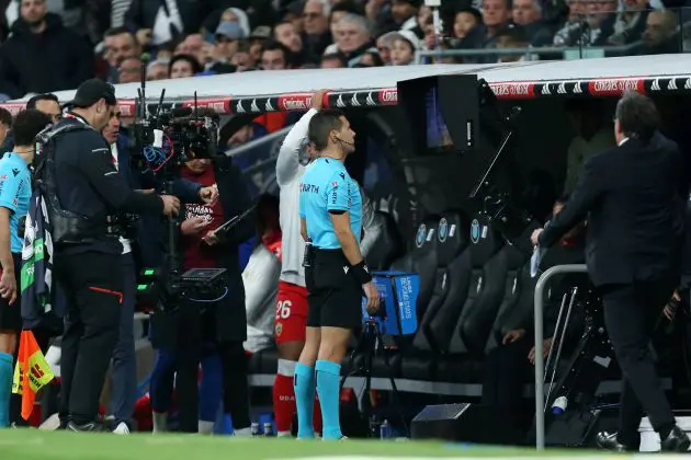 A referee checks the VAR monitor