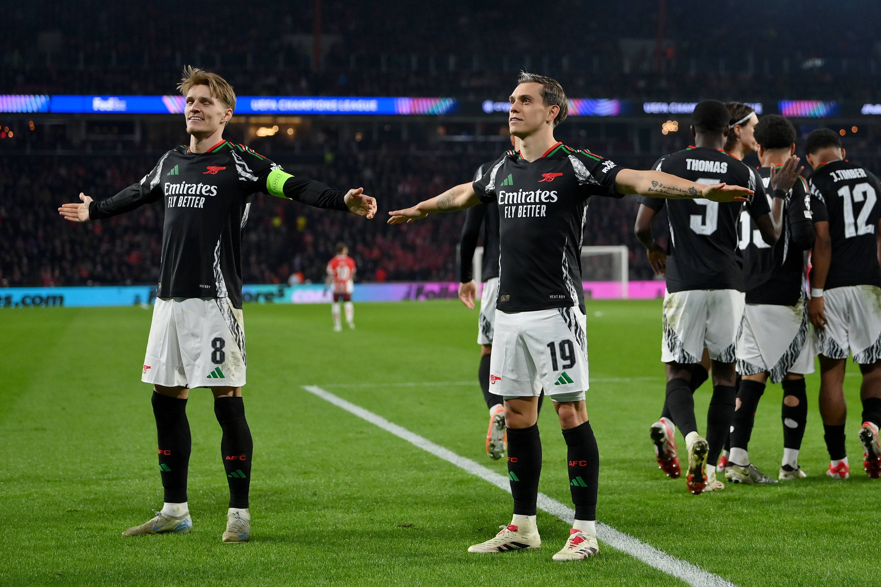 Martin Odegaard and Leandro Trossard celebrate against PSV