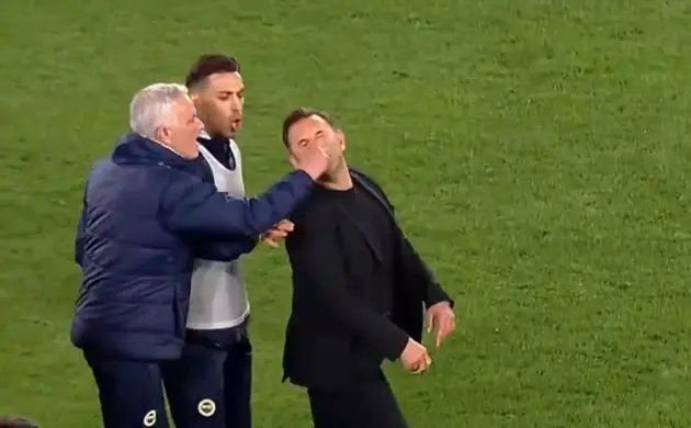 Jose Mourinho appearing to grab the nose of Okan Buruk