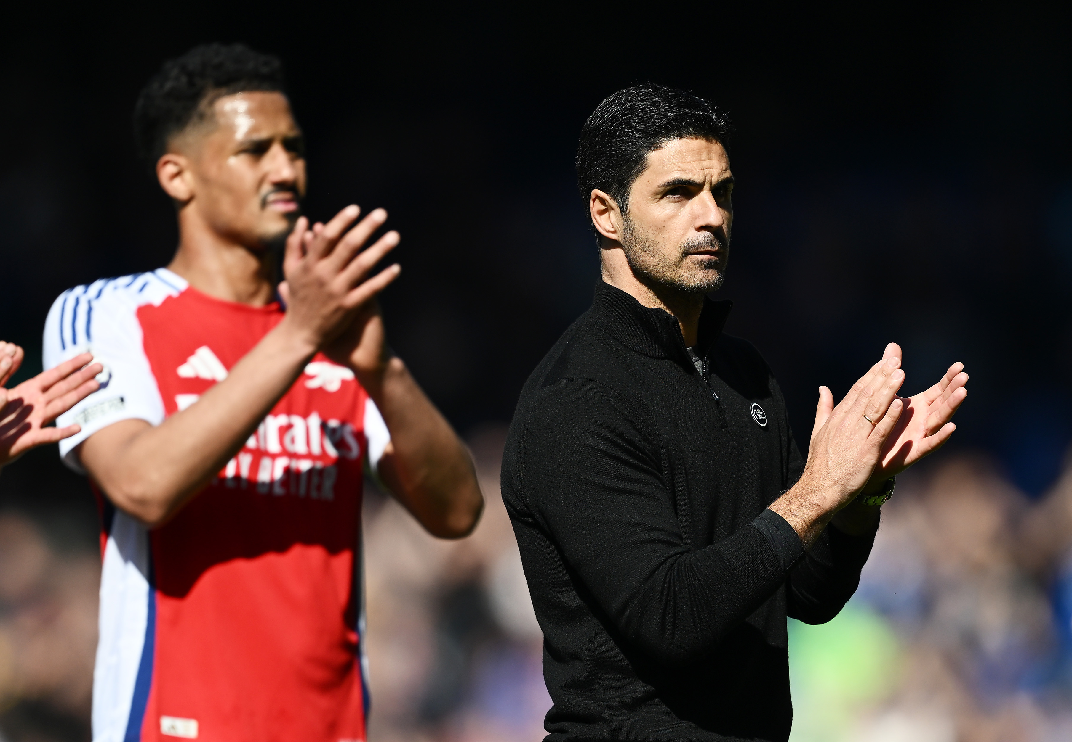 William Saliba and Mikel Arteta applaud the Arsenal fans