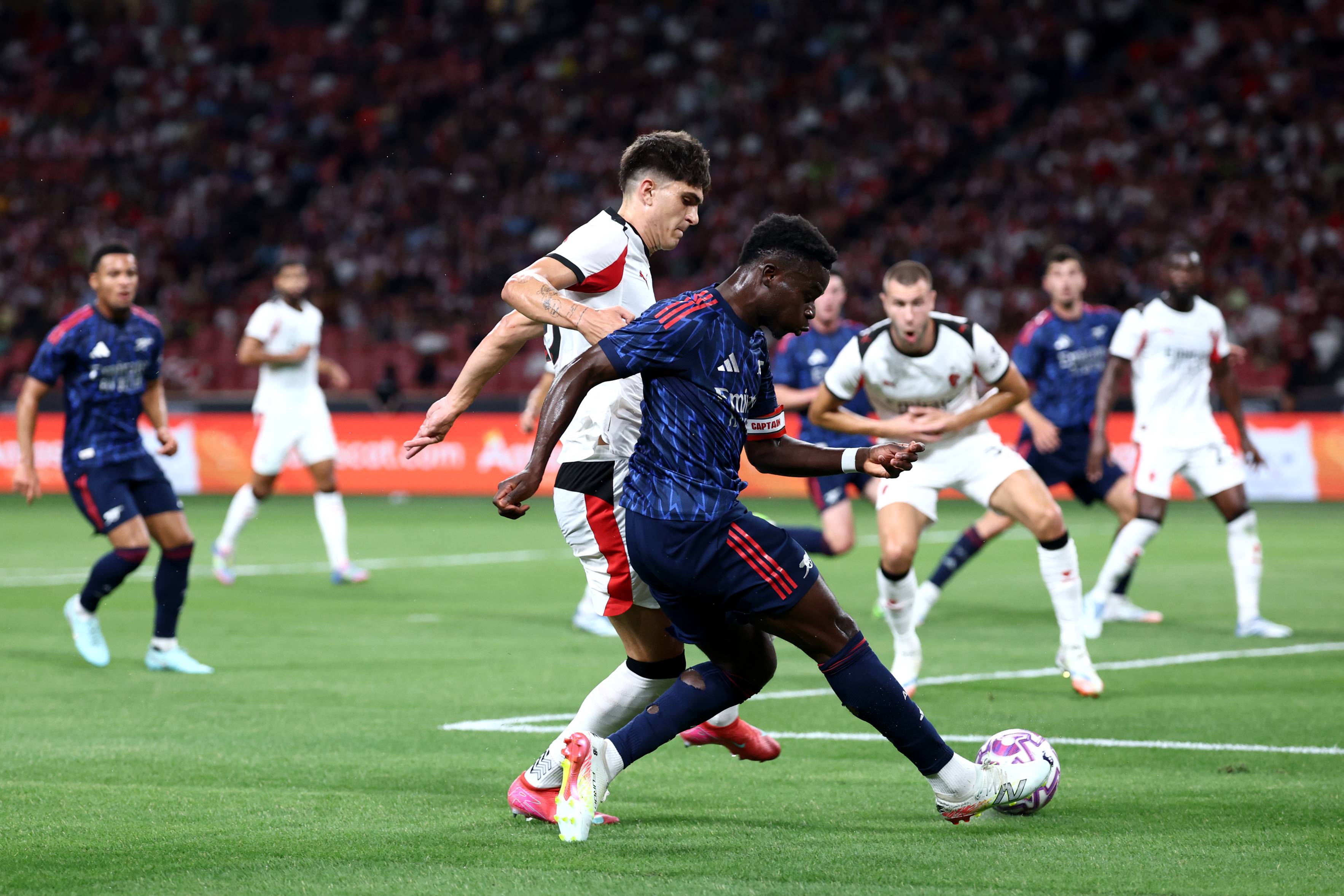 Bukayo Saka in action against AC Milan