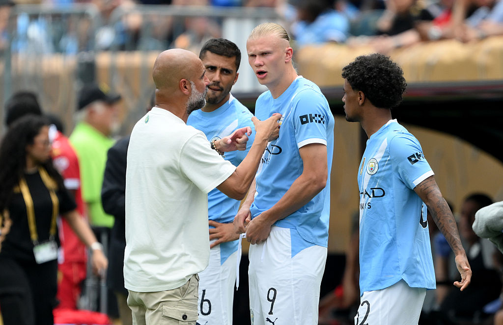 Pep Guardiola speaks to his players