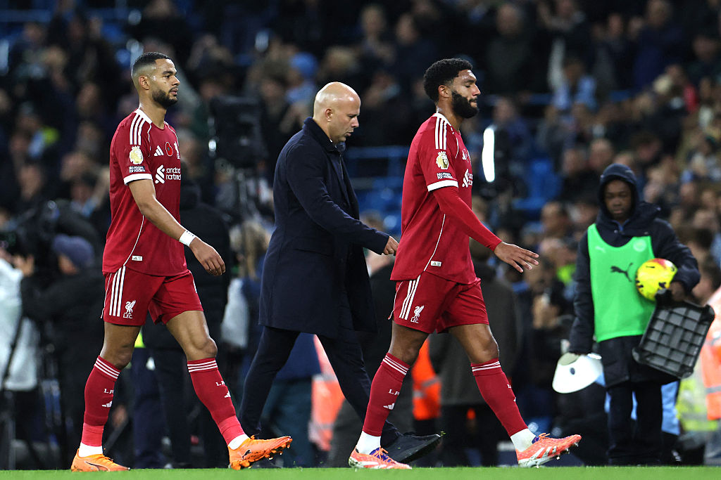 Liverpool boss Arne Slot walks off with his players after defeat at Man City