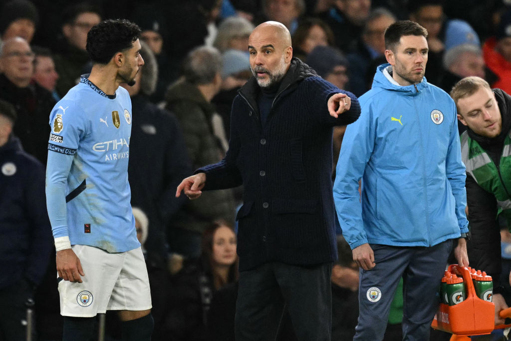 Pep Guardiola speaks to Omar Marmoush
