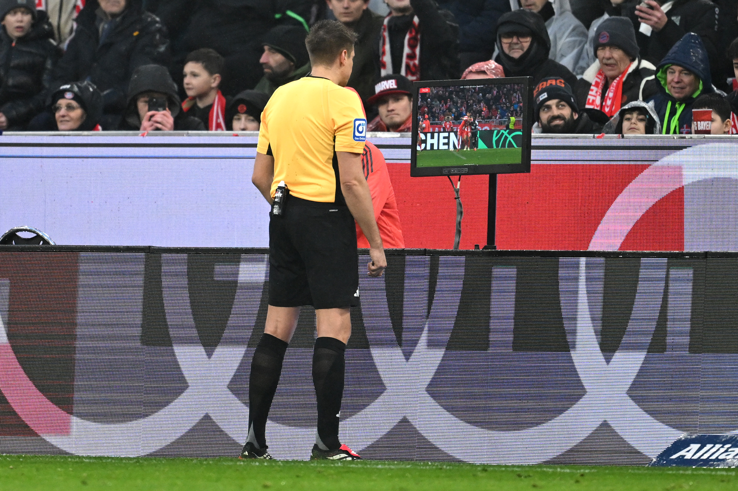 A referee looks at the VAR monitor