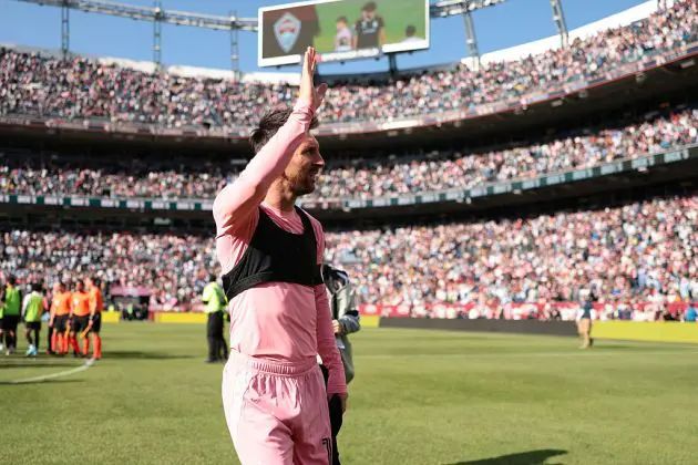 Lionel Messi waves to the fans