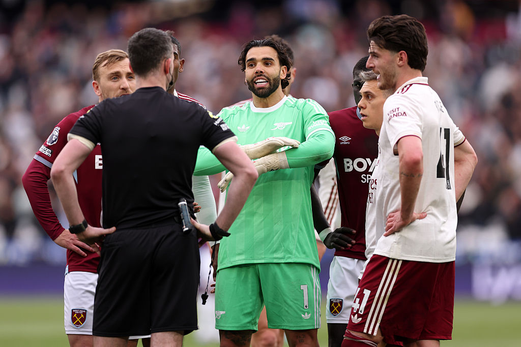 Referee Chris Kavanagh speaks to the players of both teams