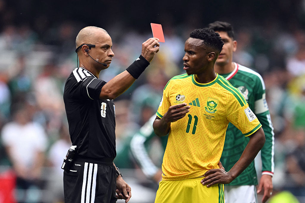 Brazilian referee Wilton Sampaio shows a red card to South Africa's Themba Zwane